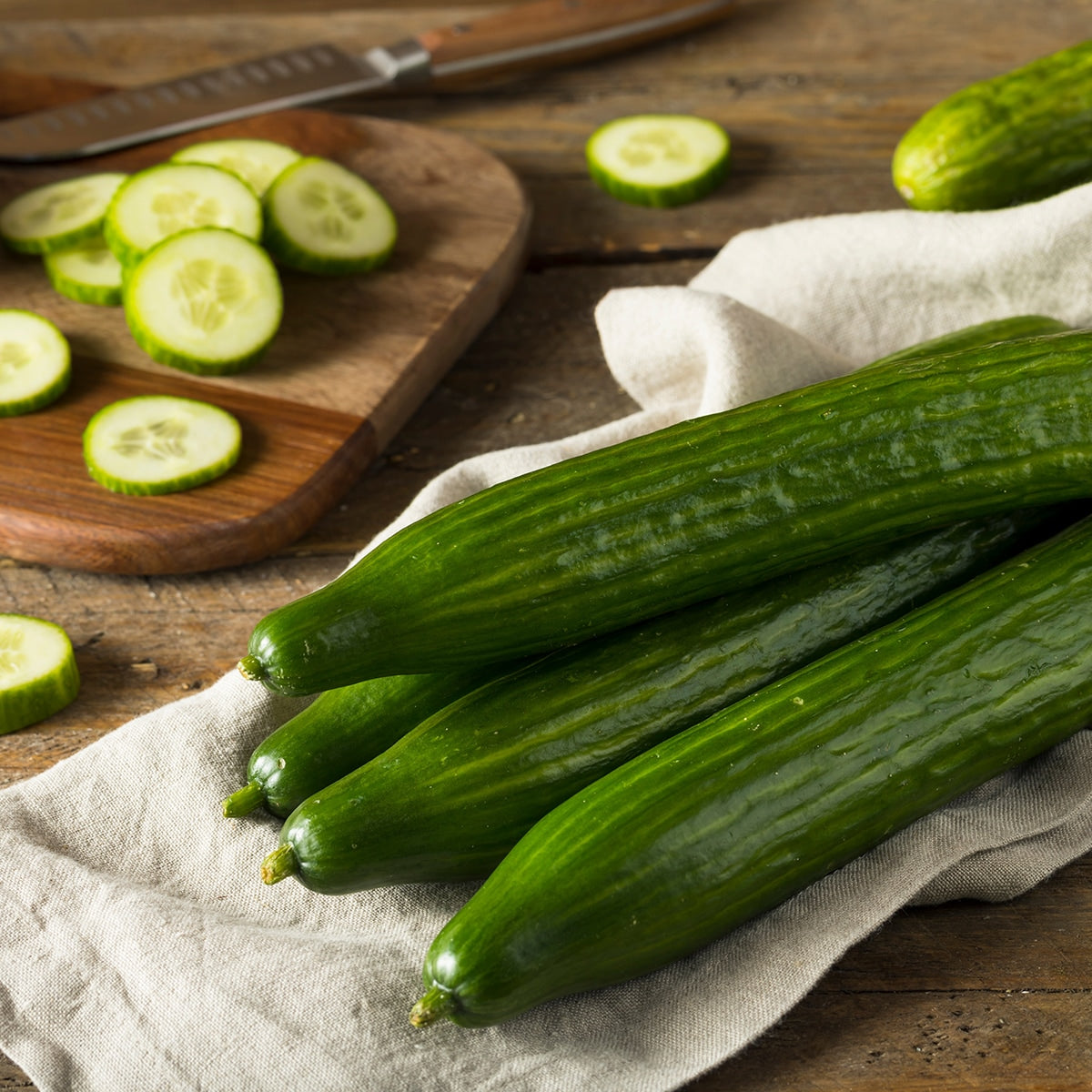Cucumbers on a wooden surface cut up