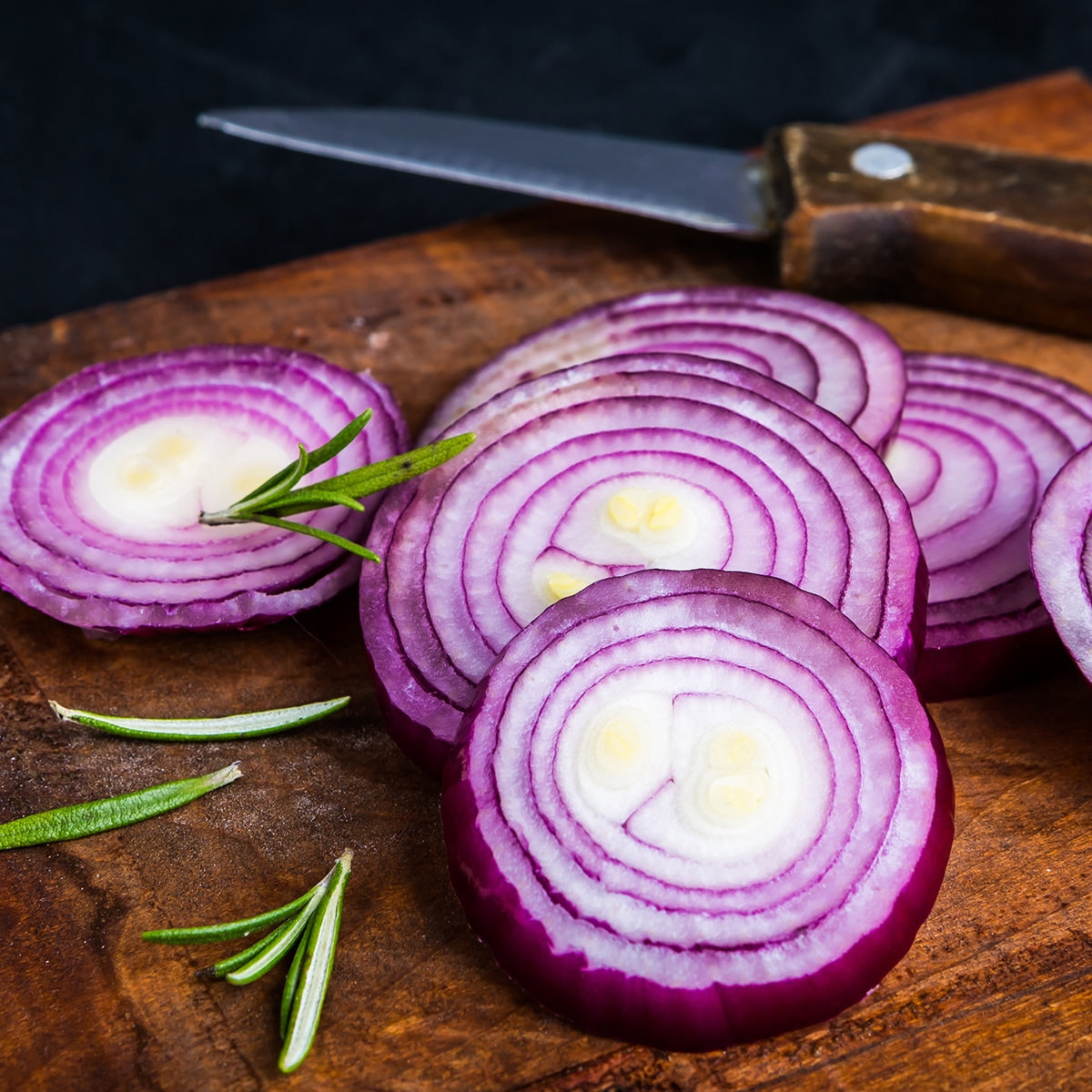 Red Creole Onions Slices on a cutting board
