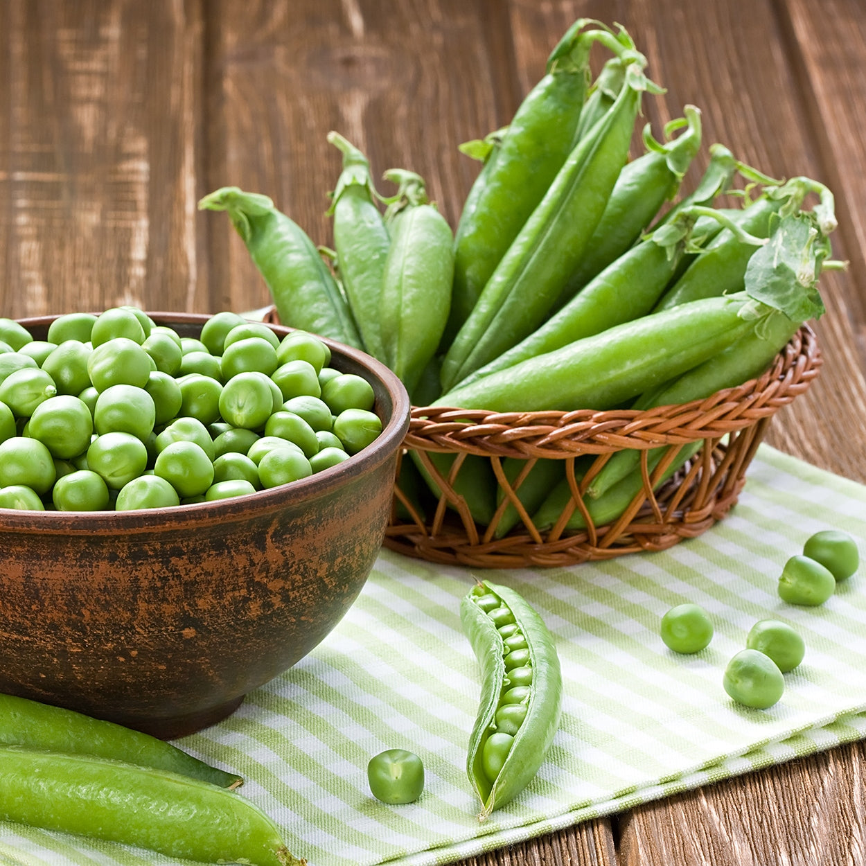 Snap Peas in  baskets on a counter 