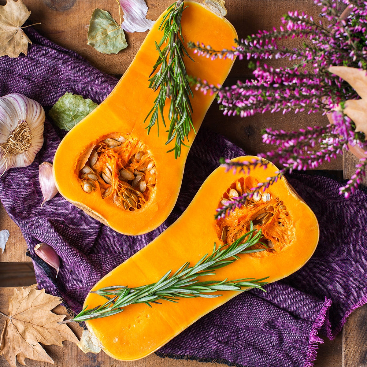 Butternut Squash Cut in half on purple fabric 